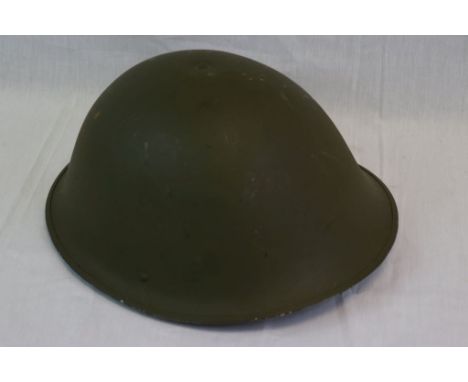 A Vintage British Army Issued Turtle Helmet Complete With Liner And Chin Strap.
