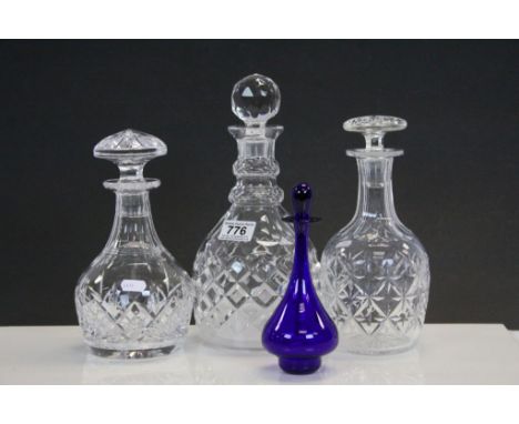 A small Bristol blue decanter and three other cut glass decanters.
