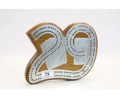 Teak Cribbage Board, the white metal board in the form of ' 29 ' and featuring playing cards, 25cms x 19cms