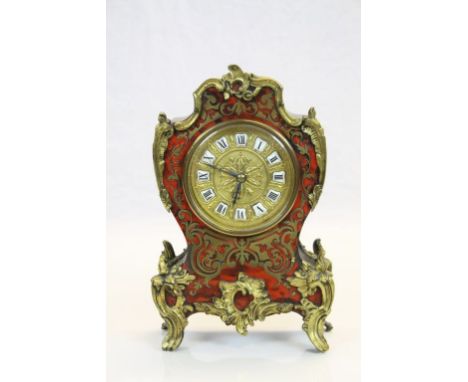 French boulle work mantle clock, raised on gilt cast feet, cast scrolling decoration, gilt face with floral decoration to cen