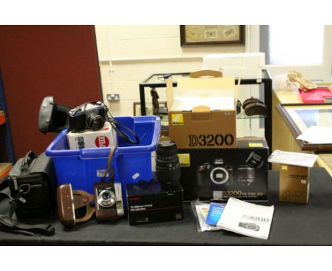 Quantity of cameras and equipment to include a boxed Nikon D3200 with an AFSDX zoom, a boxed Sigma 70-300mm lens a vintage Vo