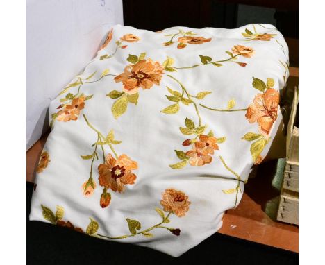 A pair of peach floral embroidered curtains on white linen ground 