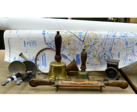 Two brass hand bells, a paraffin cycle lamp, two souvenir Spanish swords, knife and fork set and a group of aeronautical maps