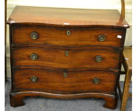 A George III mahogany serpentine fronted three height chest of drawers