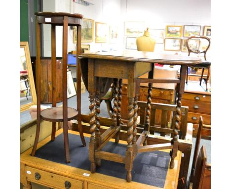 An oak drop leaf occasional table and a two tier plant stand