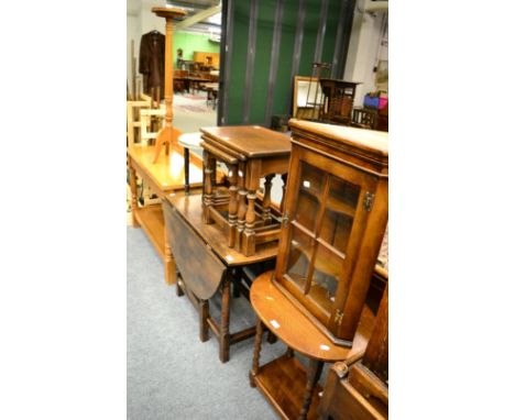 A small group of oak furniture including a gate leg dining table, a nest of three tables, an oval occasional table, glazed ha