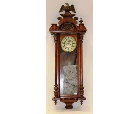VICTORIAN MAHOGANY VIENNA WALL CLOCK
with carved architectural pediment and eagle finial, the dial with Roman numerals, with 