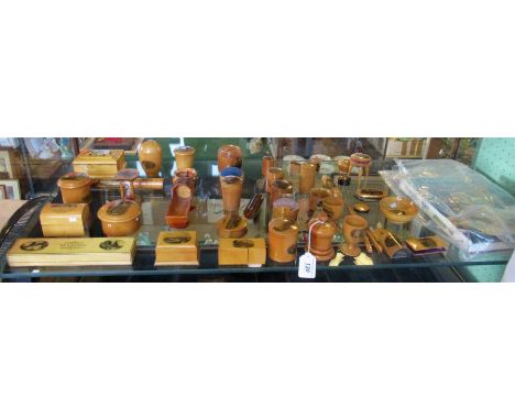 A large collection of Mauchline Ware, to include: egg timer, pin cushions, cauldron, cradle, egg cups, glove stretchers and o