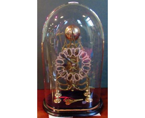 A 19th century Gothic-style skeleton clock under glass dome.