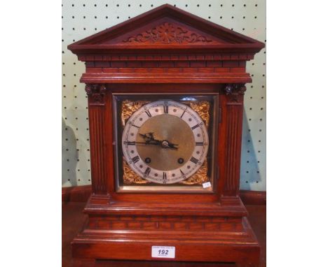 An Edwardian oak Palladian-style mantle clock.