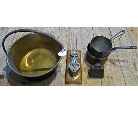 A brass jam pan, together with two saucepans, a door knocker and a cow bell.