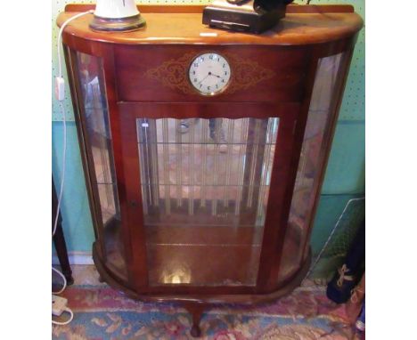 A 20th century walnut bow fronted single door china cabinet with integral Smith's clock.