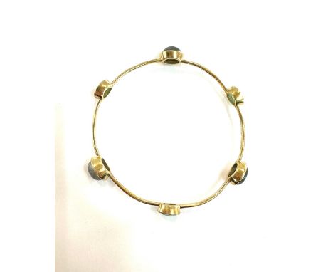 Arts and crafts yellow metal bangle set with head stones gross weight 11.5grams 
