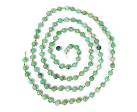 A string of one hundred and seven apple green jade beads, late 19th or early 20th century, a/f string broken and one bead loo