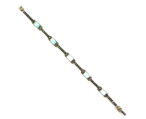 A silver, marcasite and opal set bracelet, in the Art Deco style, the links formed by six marcasite set bars,  with five opal