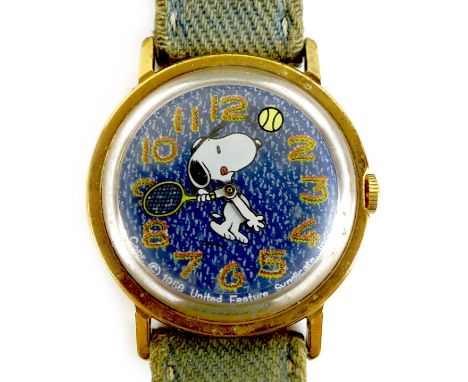 A vintage Timex 'Snoopy Tennis' mystery dial wristwatch, circa 1960s, circular blue 'denim' dial with large red and yellow Ar