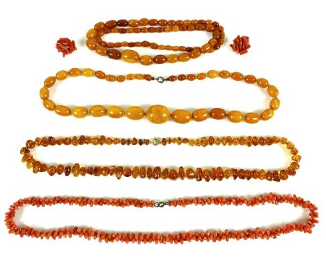 A group three amber necklaces with gold plated ring clasps, two butterscotch coloured, one with thirty five shaped beads, 18m