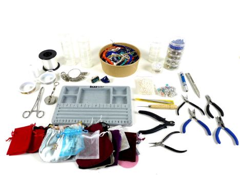 A collection of costume jewellery making items and costume jewellery, including a number of tools and pliers, beading board, 