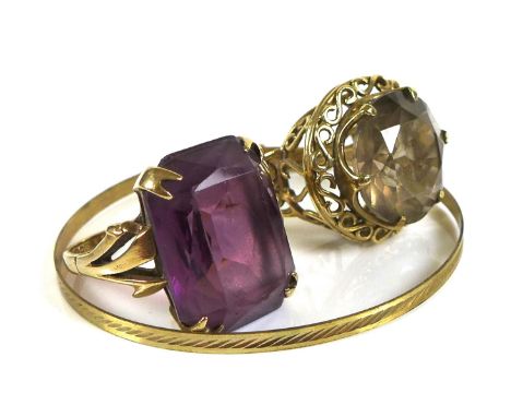 Two 9ct gold dress rings, one set with a large emerald cut amethyst, 19.88 by 14.0mm, size S, 8.9g, the other set with large 