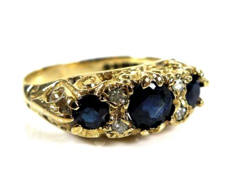 A 9ct gold and sapphire Victorian style ring, central sapphire approx 5mm by 4.5mm, further set with four diamonds, scrollwor