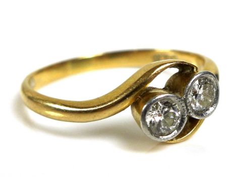 An 18ct gold and two stone diamond ring, size O/P, 2.7g. 