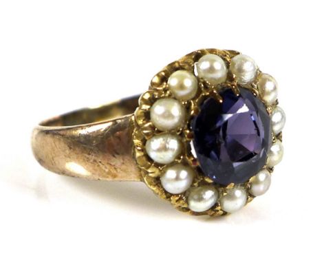 A seed pearl and lilac stone dress ring, the central stone testing as sapphire, 7.0mm  surrounded by seven half seed pearls, 