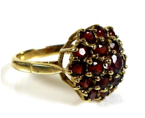 A 9ct gold and garnet cluster dress ring, of nineteen small garnets in a double flowerhead form, size O, 4.4g. 