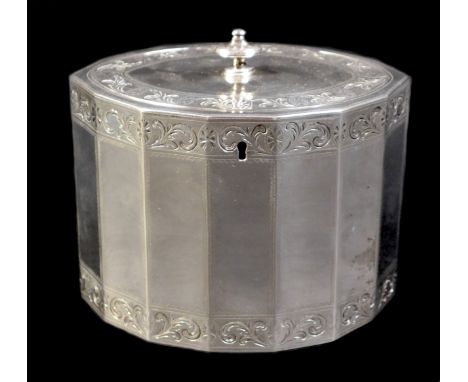 A George III silver tea caddy, of fourteen sided navette form, the oval flush hinged cover with knop finial, decorative folia