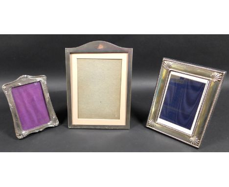 A group of three silver picture frames, comprising a frame with engine turned decoration, Mappin and Webb, Birmingham 1947, 2