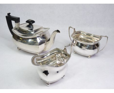 SILVER TEA SERVICE - three piece, each of plain form with feather edge rims and on four ball feet, 30ozs gross, Chester 1926