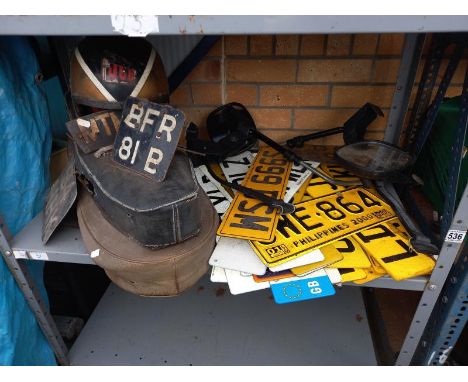 2 motorcycle seats, a quantity of&nbsp; American &amp; British number plates and a vintage helmet etc.&nbsp;Collect Only.