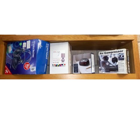 A boxed cordless FM headphones lamp, clock radio and 12 volt air compressor