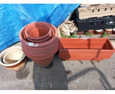A quantity of brick red plastic plant pots, troughs &amp; 2 ceramic pots. Collect Only