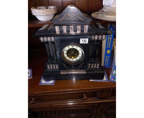 An old slate mantel clock, springs ok.