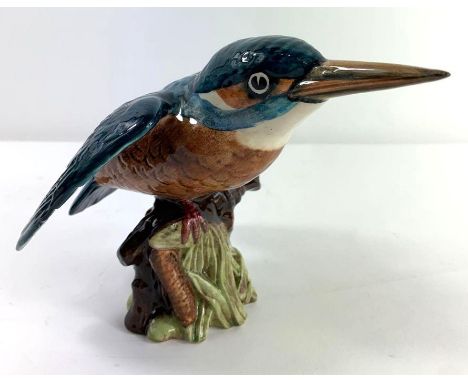 A Beswick ceramic figure of a kingfisher, perched on a branch with reeds below, black marks to base, 12cm high