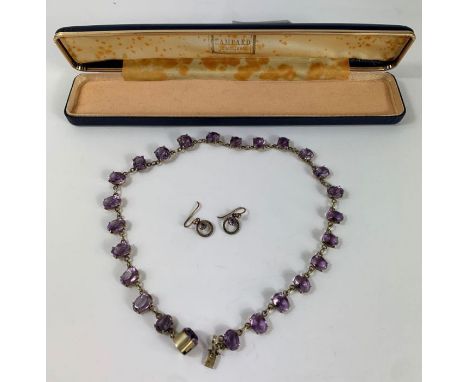 A vintage purple paste stone necklace, and a pair of earrings