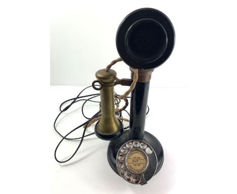 An early 20th century stick telephone, with brass listening piece and adjustable black plastic microphone; 31cm high