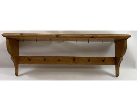 A Victorian pine hanging shelf, set with fourteen brass hanging hooks, 37cm high,103cm long, 23cm deep 