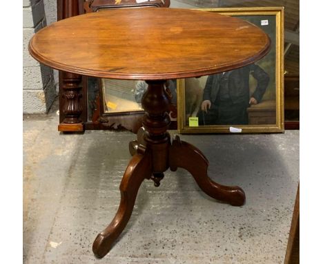 A 20th century mahogany tilt top table, standing on a tripod base, 77cm high, 83cm long, 69cm diameter 