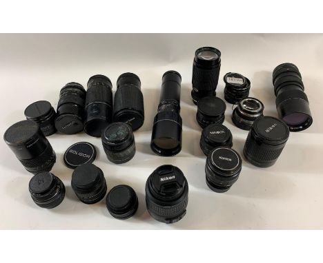 A collection of vintage camera lenses including Nikon, Konica, Minolta and others 