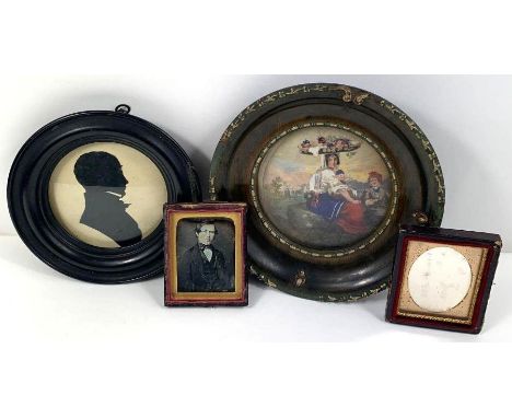 Two miniature Victorian photographic portraits on glass, both in gold mounts and glazed; a silhouette portrait of a gentleman