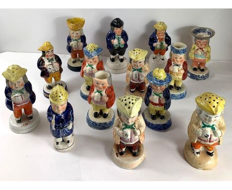 A collection of Victorian Staffordshire style ceramic novelty salt and pepper shakers, all in the form of men holding tankard