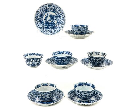 Depicting flowers in a garden, saucers are 13 cm. in diameter, chip and hairline.