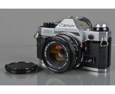 A Canon AE-1 Program SLR Camera,  chrome, shutter working, meter responsive, responsive in program, self timer working, body 