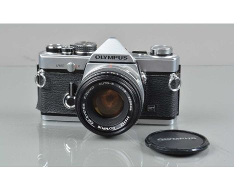 An Olympus OM-2 MD SLR Camera,  shutter working, responsive in auto, film advance lever slow to return, meter responsive, sel