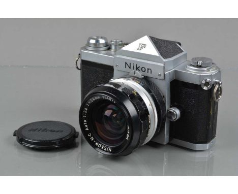 A Nikon F SLR Camera, chrome, with eye level finder, shutter working, self timer working, body G, light scratches to base pla