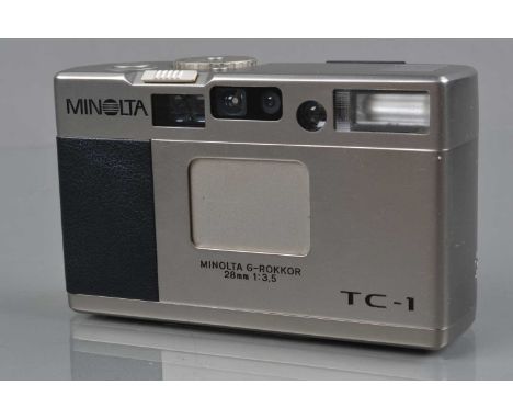 A Minolta TC-1 Compact Camera, shutter working, flash working, meter responsive, finder display working, otherwise untested, 