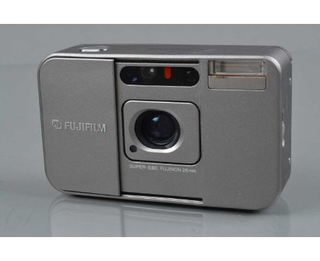 A Fujifilm DL Super Mini Compact Camera, shutter working, flash working, self timer working, body G, tiny ding L/H bottom cor