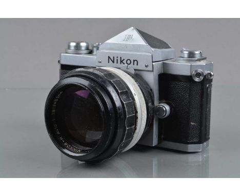 A Nikon F SLR Camera, chrome, with eye level finder, shutter fires in one speed, self timer working, body F, wear & ding to t