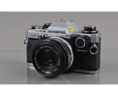 An Olympus OM-10 SLR Camera, shutter working, self timer working, meter/shutter responsive in auto, with manual adapter, body